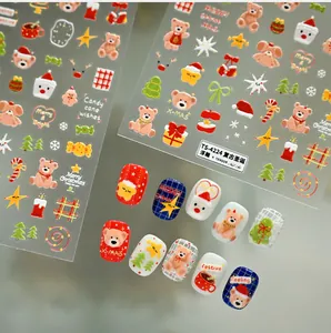 Detailed view of embossed Christmas nail art stickers featuring bear and Santa motifs