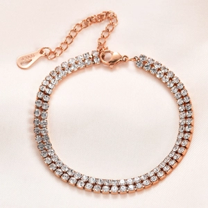 Macro view of 6mm double-row rhinestone rose gold bracelet with lobster clasp and chain