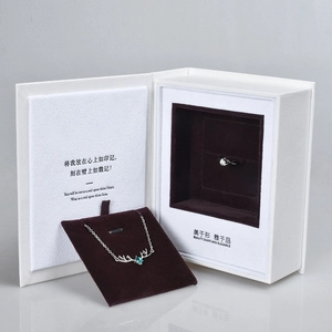 Book-style jewelry gift box with antler necklace and twisted ring set on velvet