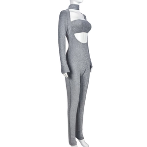 Detail of silver long sleeve bodysuit with cutout waist and glittery fabric finish
