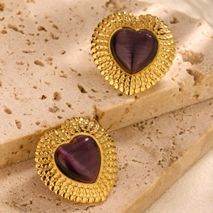 French style gold heart earrings with purple stone on minimalist stone background