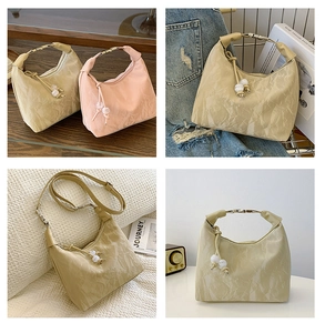 Detailed macro view of pleated texture bag with metallic handles and bead accents