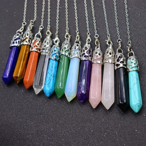 Detailed row of twelve hexagonal crystal point pendants in assorted natural stones