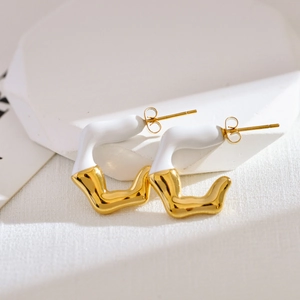 Detail of irregular C-shaped gold-plated stainless steel earrings with white enamel finish