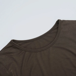 Close-up of the round neckline and double-stitch sewing on a dark brown knit dress