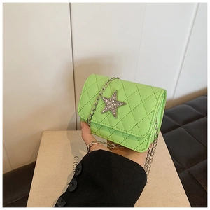Detail of neon green quilted crossbody bag with rhinestone star and silver chain
