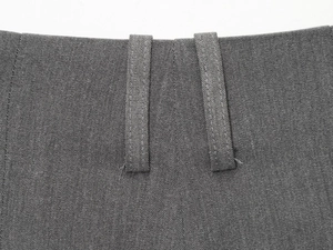 Detail of belt loops and high-quality woven texture on dark grey casual long shorts