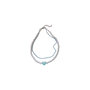 Double-layered pearl choker necklace featuring blue beads and a heart-shaped pendant