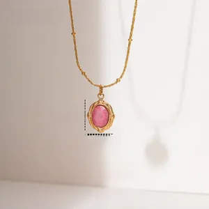Macro shot of oval rhodochrosite pendant with 18K gold plated stainless steel bead chain