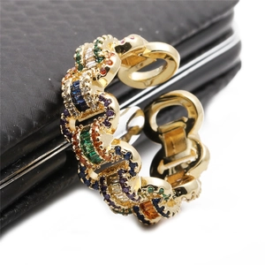 Macro view of gold chain link ring with colorful rectangular-cut zircon stones