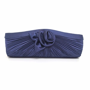 Detailed view of navy blue satin clutch with pleated design and 3D fabric rose flower