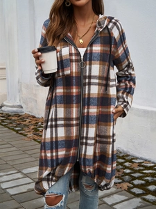 Detail view of the brown, blue, and white plaid hooded zip-up cardigan jacket outdoors