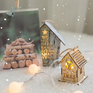Illuminated wooden Christmas house ornament with warm LED light and XMAS engraving