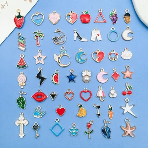 Detailed flat lay of 42 colorful alloy enamel charms in assorted shapes for DIY jewelry