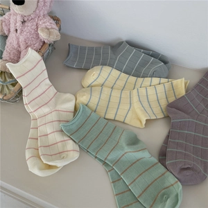 Five pairs of Morandi colored cotton crew socks with plaid patterns and rolled cuffs