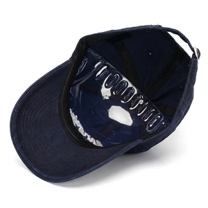 Detailed view of dark blue cotton baseball cap with adjustable metal strap and crown shape