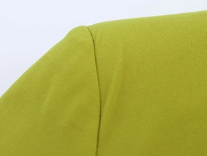 Close-up of lime green blazer fabric showing premium textured crepe and precise stitching