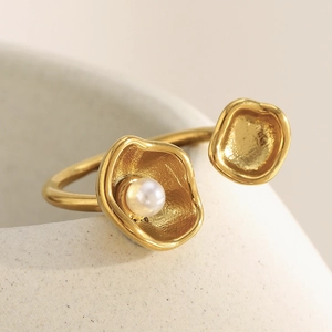 Detailed macro view of an 18K gold plated shell ring with a lustrous white pearl accent