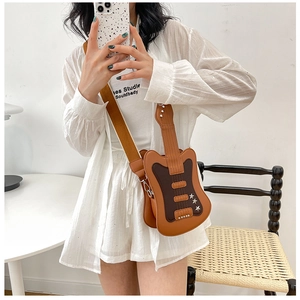 Detail of guitar-shaped crossbody bag with star rivets and brown contrast stitching