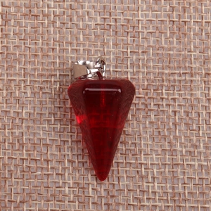 Macro shot of faceted red crystal pendulum pendant on rustic burlap background texture
