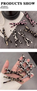Detail showing leopard print bow hair clips in pink and brown with metal duckbill structure