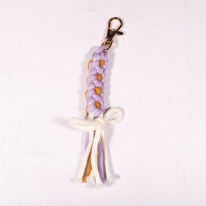 Detail of handmade bohemian daisy wristlet in purple and white cotton with gold lobster clasp