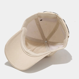 Internal structure of beige cotton baseball cap with sweatband and ventilation eyelets