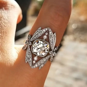 Macro detail of crown cocktail ring with cushion-cut stone and pavé-set silver leaves