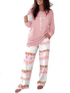 Detail of pink long-sleeve pajamas featuring Faith print and tie-dye wide-leg pants