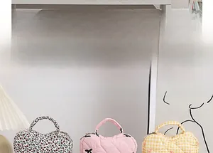 Quilted makeup bags in floral, polka dot, and plaid patterns with top handles