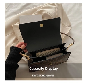 Detailed view of the leopard print bag interior showing double compartments and capacity