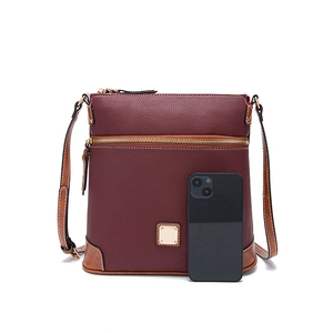 Detail of lychee texture pebble leather crossbody bag with wine red and brown accents