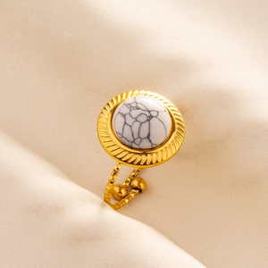 Detailed close-up of a gold stainless steel adjustable ring with a white marble stone