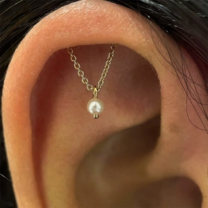Close-up of S925 silver flat back stud with pearl tassel on ear cartilage
