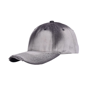 Close-up of distressed denim baseball cap featuring washed gradient and frayed hole details