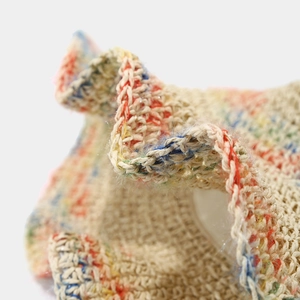 Close-up of woven straw hat showing detailed texture and colorful fiber patterns