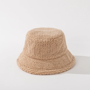 Detailed macro view of the fluffy lamb wool texture on this beige winter bucket hat