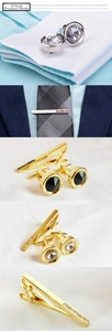 Detailed view of luxury silver and gold cufflinks with zircons on a dress shirt