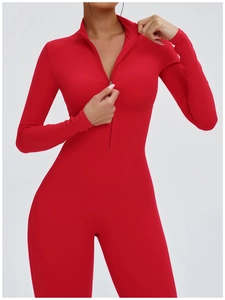 Close-up of red athletic bodysuit showing zipper detail and stretchy ribbed fabric