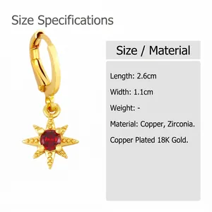 Detail of 18K gold-plated star earrings with red zircon, measuring 2.6cm by 1.1cm
