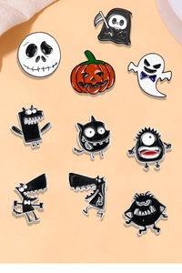 Detail of Halloween enamel pins featuring ghosts, pumpkins, and spooky cartoon characters