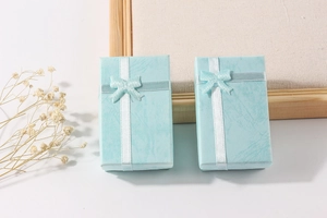 Macro shot of texture Tiffany blue jewelry boxes with elegant white ribbon and bow decoration