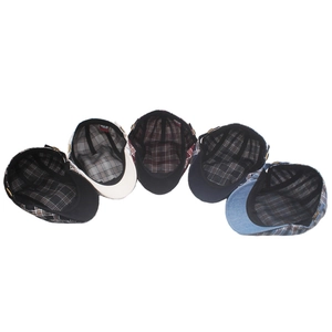 Detail view of colorful plaid beret inner lining with adjustable strap and breathable band