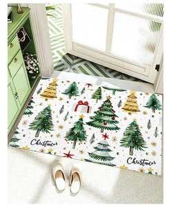 Detail of Christmas doormat with tree and star patterns in a cozy home entryway