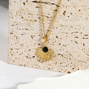 Gold-plated stainless steel necklace with fan-shaped sunburst pendant and black natural stone