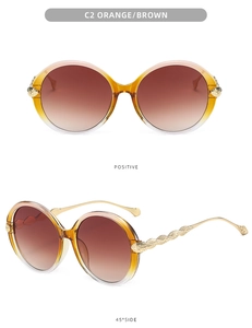 Detail of round sunglasses featuring orange brown gradient lenses and gold leaf carvings