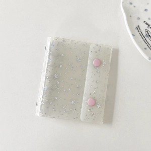 Close-up of translucent white glitter M5 binder with pink buttons for card storage