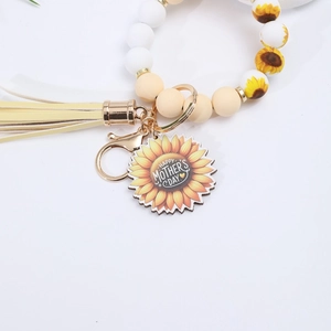 Detail of beaded keychain bracelet with Happy Mother's Day pendant and yellow tassel