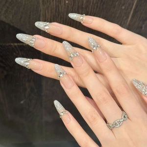 Exquisite nude long stiletto press-on nails with silver glitter and rhinestone crown