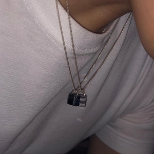 925 silver minimalist necklaces with black and clear cube resin pendants on white shirt